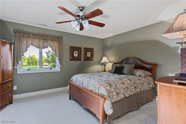 bedroom featuring ceiling fan and carpet