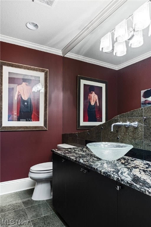 bathroom featuring crown molding, vanity, and toilet