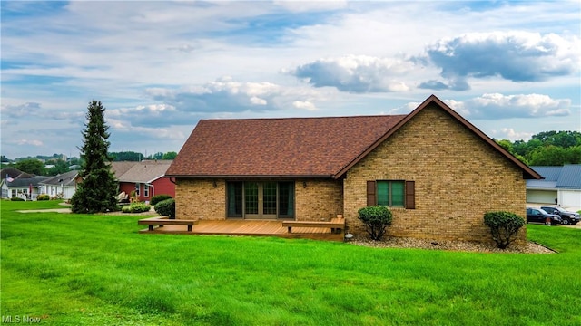 back of house featuring a lawn and a wooden deck