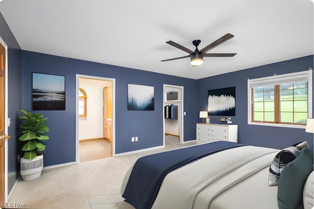 bedroom featuring ensuite bath, ceiling fan, and light carpet