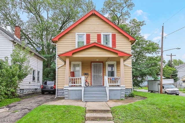 view of front facade with covered porch and a front lawn