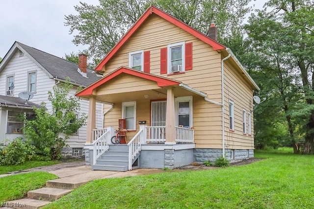 view of front of property with a front yard and covered porch