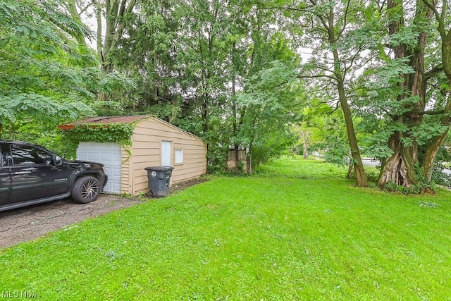 view of yard featuring a garage and an outdoor structure