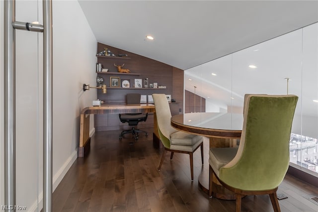 dining area with vaulted ceiling and dark hardwood / wood-style flooring