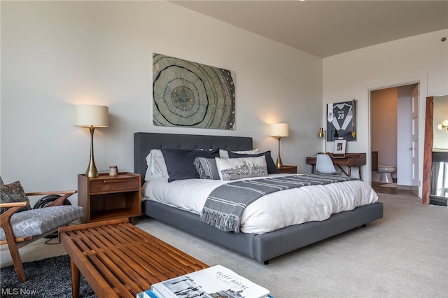 carpeted bedroom with ensuite bathroom