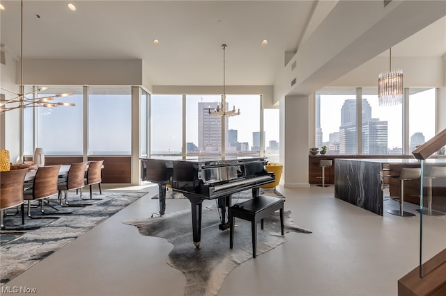 misc room with concrete floors and a chandelier