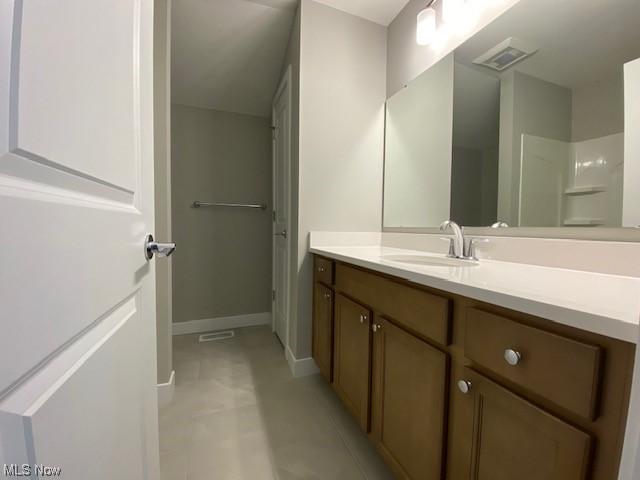 bathroom with tile patterned floors and vanity