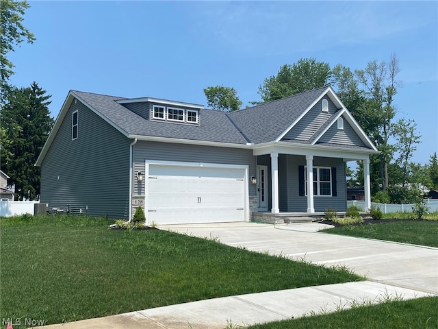 craftsman-style home with a porch, a front lawn, and a garage