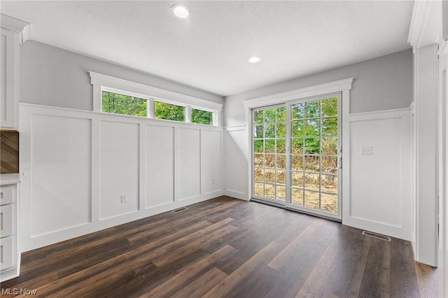 unfurnished room with dark hardwood / wood-style flooring