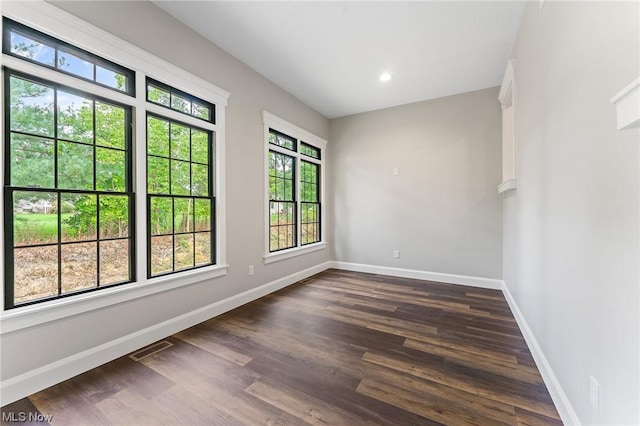 spare room with dark hardwood / wood-style flooring