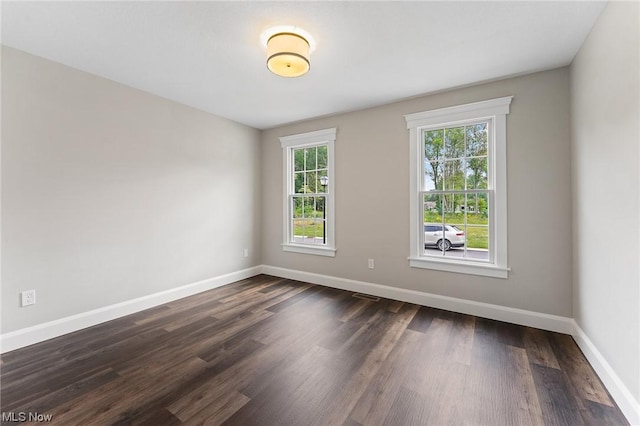 spare room featuring dark hardwood / wood-style flooring