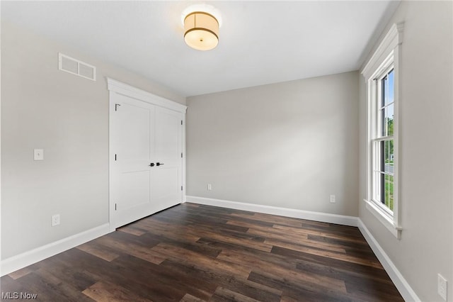 spare room with dark hardwood / wood-style flooring