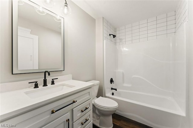 full bathroom featuring hardwood / wood-style flooring, vanity, toilet, and bathtub / shower combination