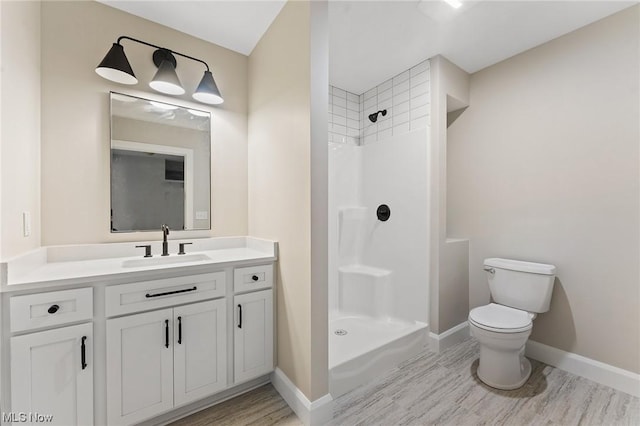 bathroom with vanity, toilet, and walk in shower