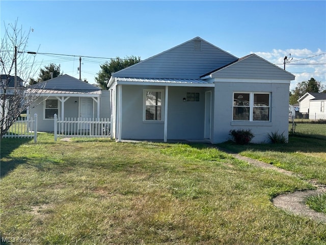 back of house with a lawn