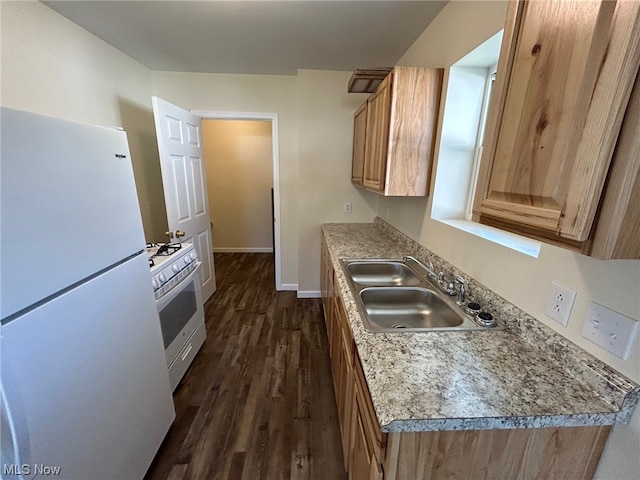 kitchen featuring dark wood-type flooring, white appliances, and sink