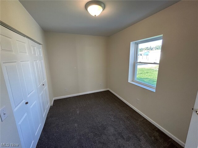 unfurnished bedroom with a closet and carpet floors