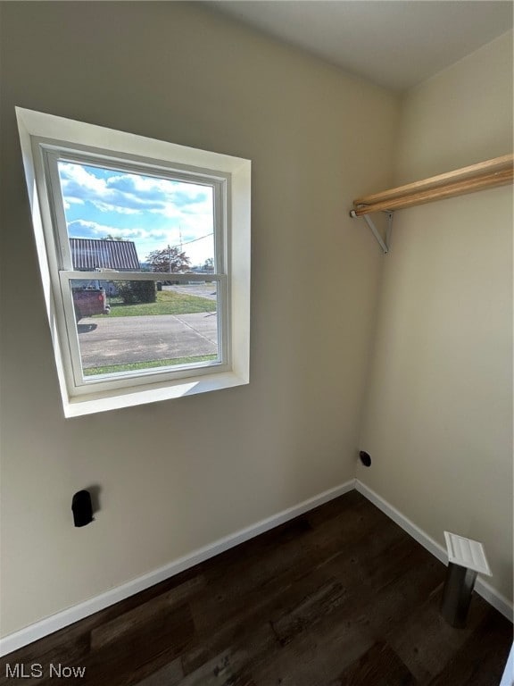 clothes washing area with hardwood / wood-style floors