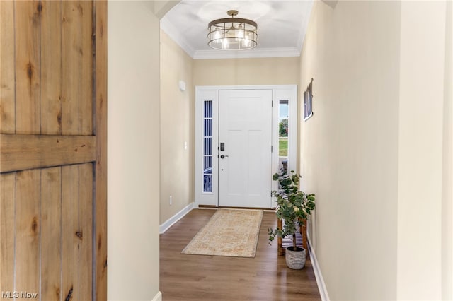 entrance foyer with hardwood / wood-style flooring and ornamental molding