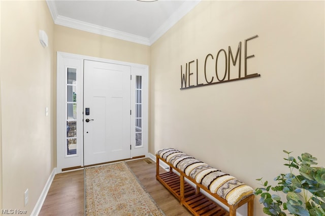 foyer featuring ornamental molding and hardwood / wood-style floors