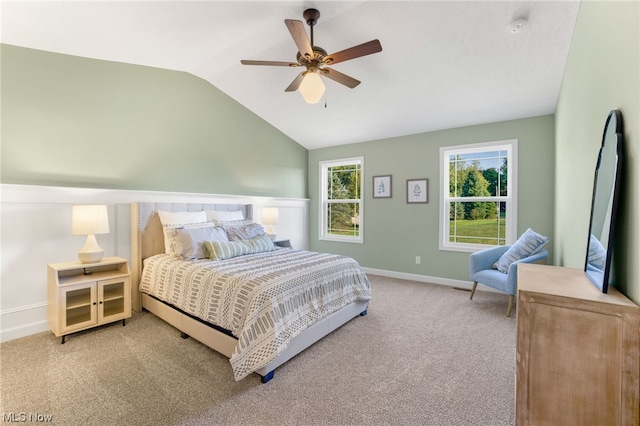 carpeted bedroom featuring lofted ceiling and ceiling fan