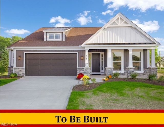 view of front facade with a garage, covered porch, and a front lawn