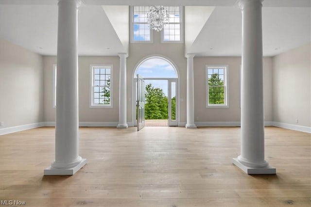 2585 Glendale Rd, Marietta, OH 45750 - foyer featuring plenty of natural light, baseboards, light wood-style floors, and decorative columns