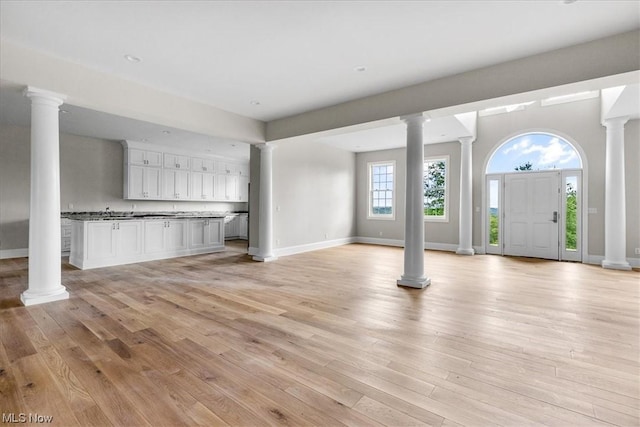 2585 Glendale Rd, Marietta, OH 45750 - unfurnished living room with light wood-style flooring, decorative columns, and baseboards
