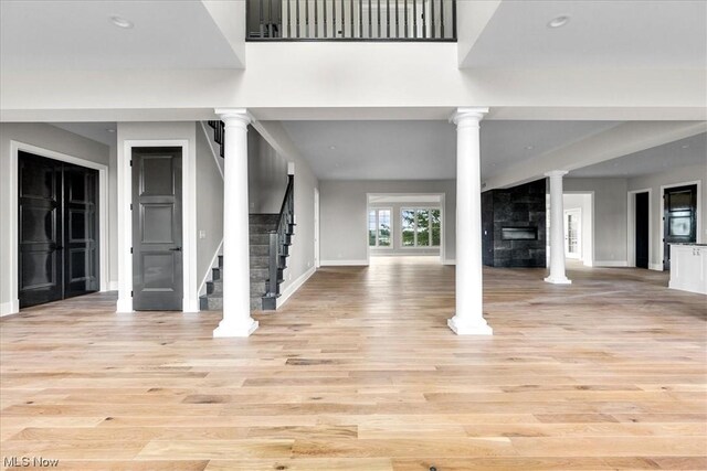 2585 Glendale Rd, Marietta, OH 45750 - entryway featuring light wood-type flooring, stairway, baseboards, and ornate columns