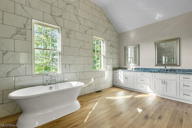 2585 Glendale Rd, Marietta, OH 45750 - bathroom with a wealth of natural light, a freestanding tub, a sink, double vanity, and lofted ceiling