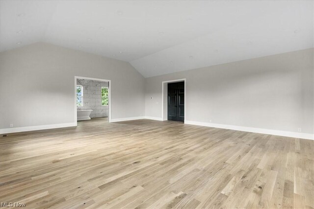 2585 Glendale Rd, Marietta, OH 45750 - empty room featuring vaulted ceiling, baseboards, and light wood-type flooring