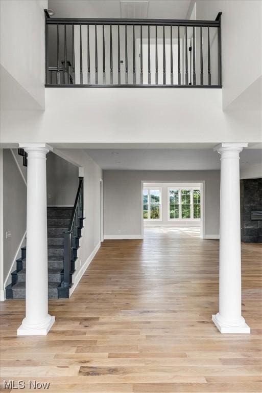 2585 Glendale Rd, Marietta, OH 45750 - interior space with wood finished floors, a high ceiling, decorative columns, baseboards, and stairs