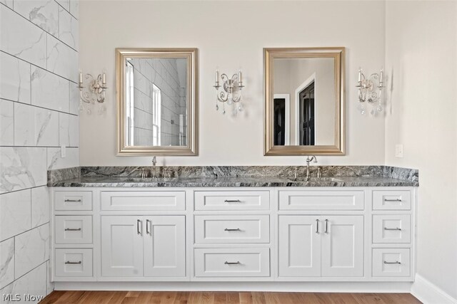 2585 Glendale Rd, Marietta, OH 45750 - full bath featuring double vanity, wood finished floors, and a sink