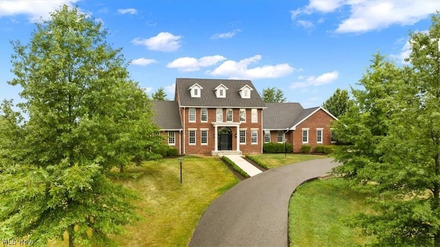 2585 Glendale Rd, Marietta, OH 45750 - view of front of home with a front yard, brick siding, and aphalt driveway