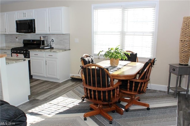 dining area featuring dark wood-type flooring