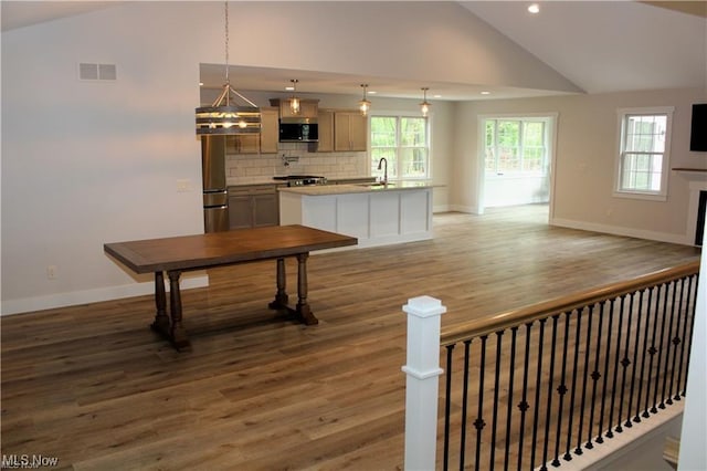 interior space featuring sink, hardwood / wood-style flooring, and high vaulted ceiling