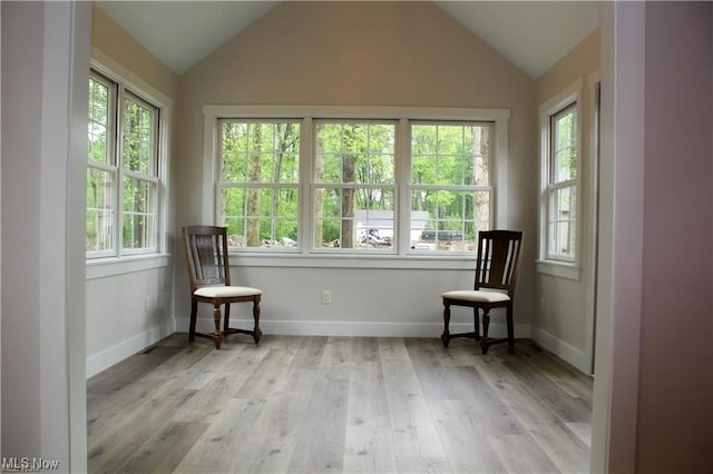 unfurnished room featuring vaulted ceiling and light wood-type flooring