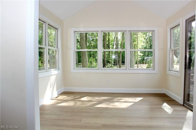 unfurnished sunroom with lofted ceiling