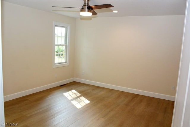 unfurnished room with ceiling fan and light wood-type flooring