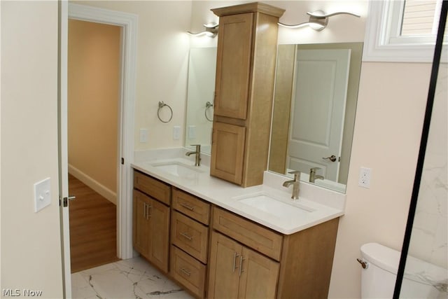 bathroom featuring vanity and toilet