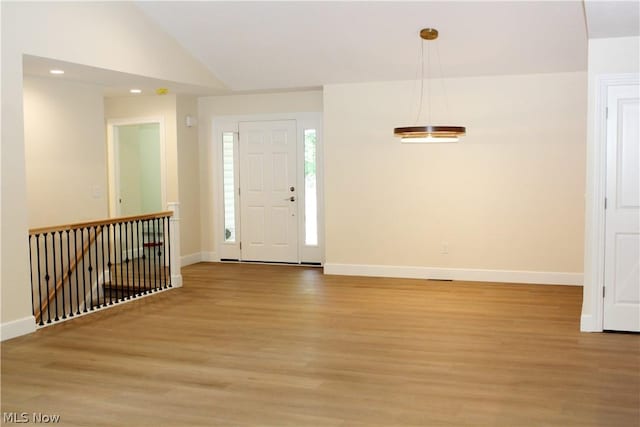 foyer with lofted ceiling and light hardwood / wood-style flooring