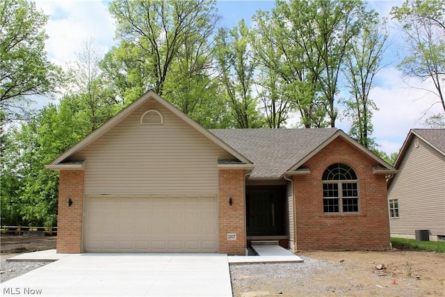 ranch-style house with central AC and a garage