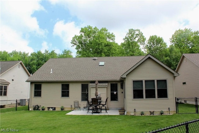 rear view of house featuring central AC unit, a patio area, and a lawn