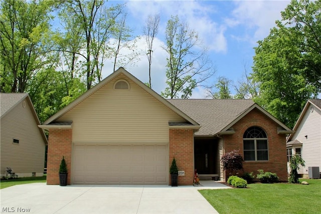 single story home with cooling unit, a garage, and a front yard