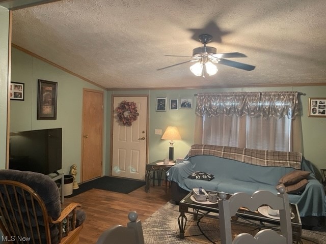 recreation room featuring ceiling fan, hardwood / wood-style flooring, a textured ceiling, and lofted ceiling