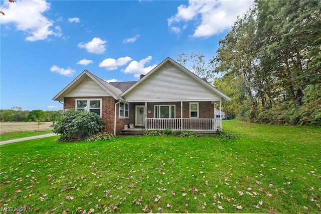 view of front of house with covered porch and a front lawn