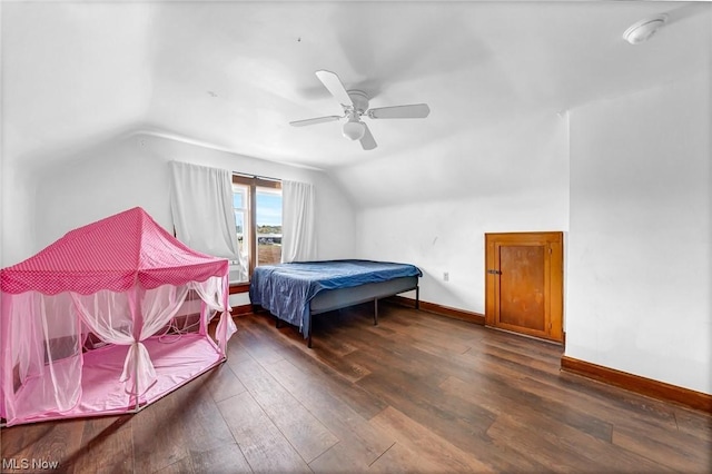 bedroom with ceiling fan, dark hardwood / wood-style floors, and vaulted ceiling