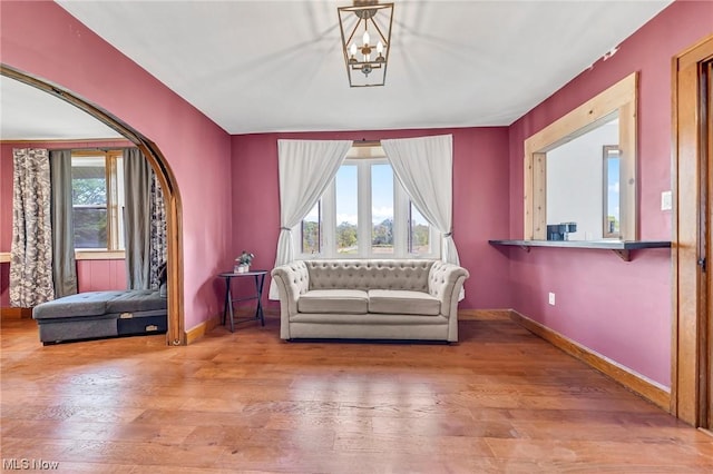 unfurnished room with wood-type flooring and a notable chandelier