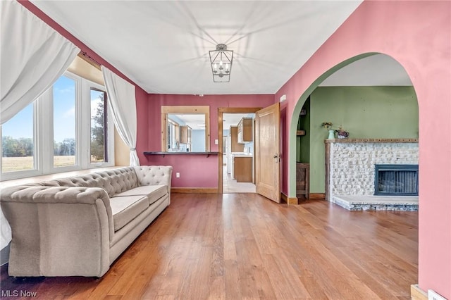 living room with wood-type flooring and a fireplace