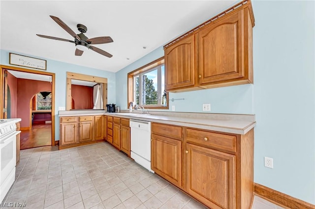 kitchen featuring white appliances, ceiling fan, and sink